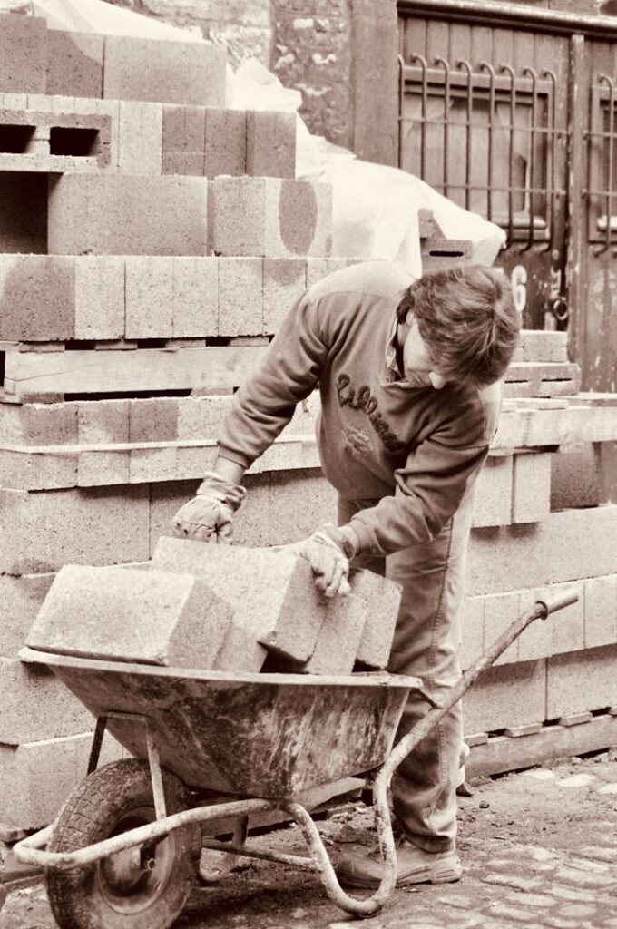 Man Loading Bricks on Wheelbarrow